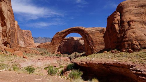 Low angle view of rock formations against blue sky at glen canyon