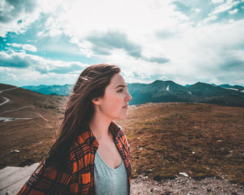 Young woman on mountain against sky