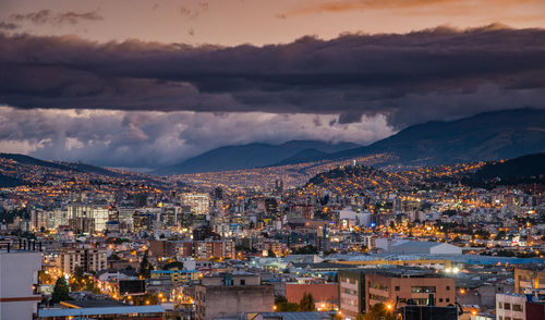 High angle view of illuminated cityscape against sky at dusk