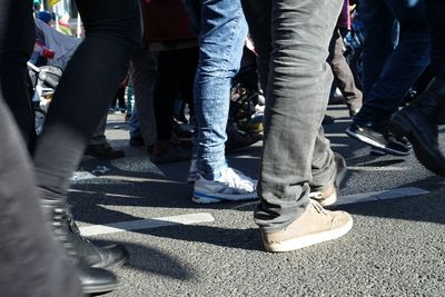 Low section of people standing on tiled floor