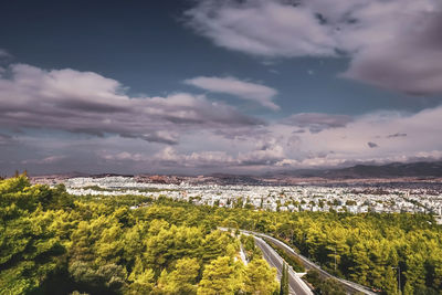 High angle view of road amidst plants in city against sky