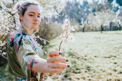 Man holding flower on field