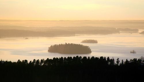 Scenic view of lake against sky during sunset