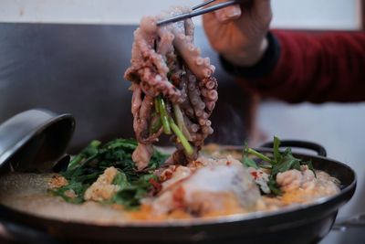 Close-up of hand holding meat