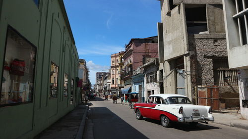 Cars on street amidst buildings in city