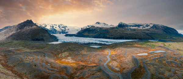 Beautiful glaciers flow through the mountains in iceland.