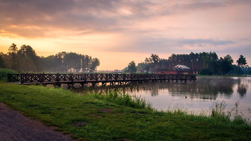 Bridge over river against sky during sunset. krasnobrod