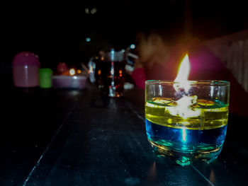 Close-up of fire in drink on table at bar