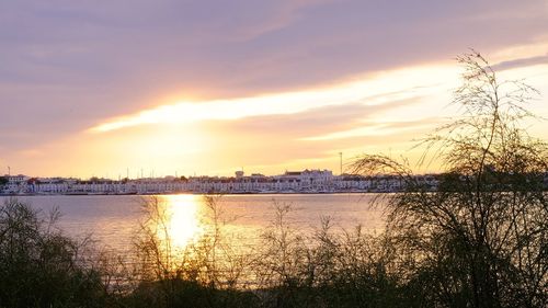 Scenic view of lake against sky during sunset