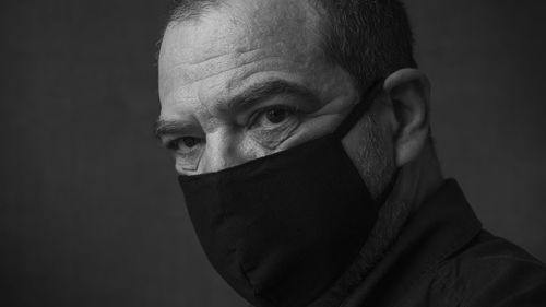 Mature man in black medical mask close-up face