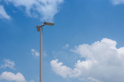 Low angle view of floodlight against blue sky