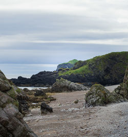 Scenic view of sea and rocks against sky