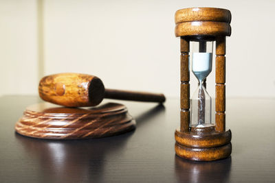 High angle view of gavel with hourglass on wooden table