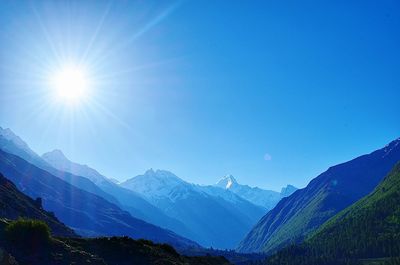 Scenic view of mountains against clear blue sky