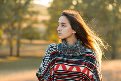 Portrait of young woman standing outdoors