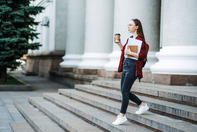 Scholarships grants for college students. happy college student girl with laptop and books near