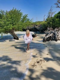 Woman on beach against sky