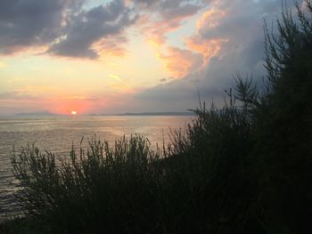 Scenic view of lake against sky during sunset
