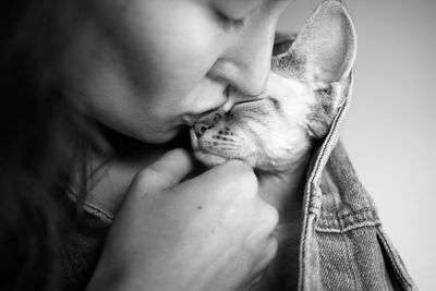 Close-up of woman kissing kitten