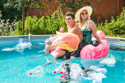 Woman sitting in swimming pool