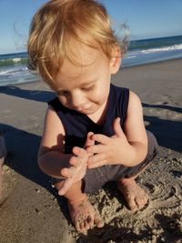 Cute boy on shore at beach