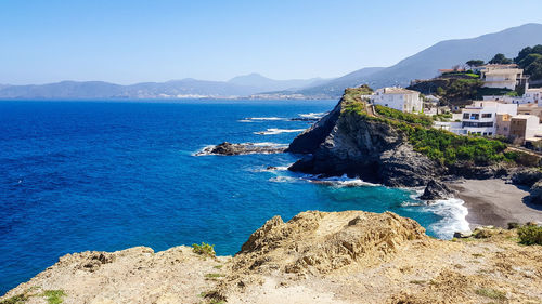 Scenic view of bay against clear blue sky