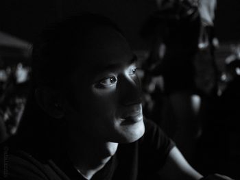 Close-up portrait of a young man looking away