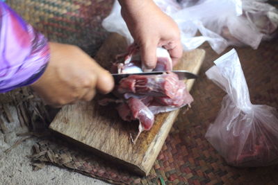 High angle view of man preparing food on cutting board