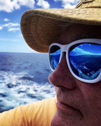 Close-up of man wearing sunglasses by sea