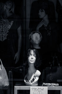 Portrait of young woman looking away at store