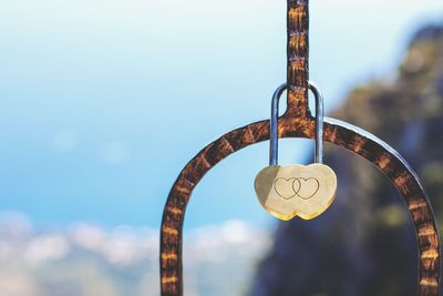 Close-up of heart shape hanging against sky