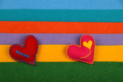 Close-up of heart shapes craftwork on colorful material at table