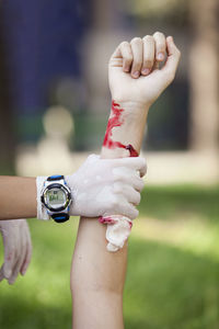 Cropped image of person holding blooded hand