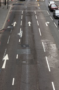 High angle view of arrow symbol on road in city