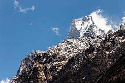 Low angle view of rocky mountains against sky