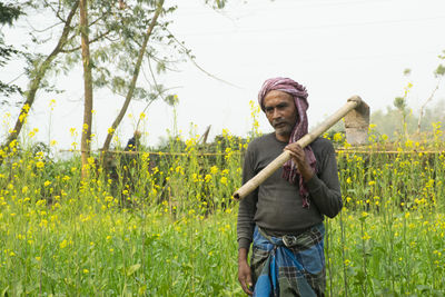 Portrait of man standing on field