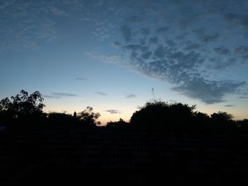 Low angle view of silhouette trees against sky at sunset