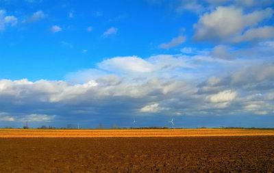 Scenic view of field against blue sky