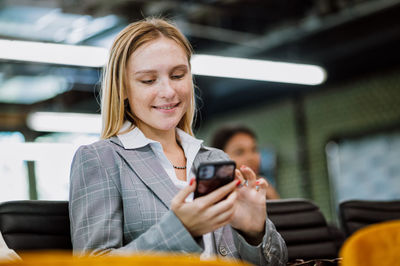 Portrait of young woman using mobile phone