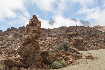 Rock formations on landscape against sky