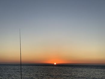 Scenic view of sea against orange sky