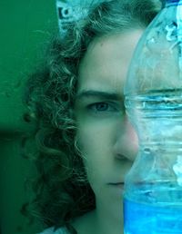 Close-up portrait of woman with water bottle