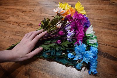 High angle view of woman holding flower bouquet on floor