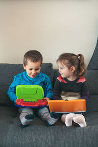 Boy sitting on sofa at home