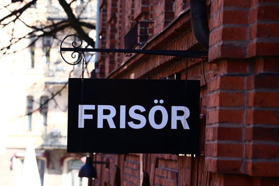 Low angle view of information sign on wall