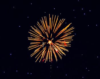 Low angle view of fireworks in sky at night