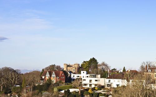 Buildings in town against sky