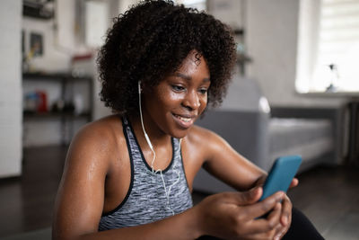 Sweaty black woman listening to music