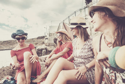 Smiling friends sitting outdoors