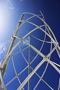 Low angle view of ferris wheel against blue sky